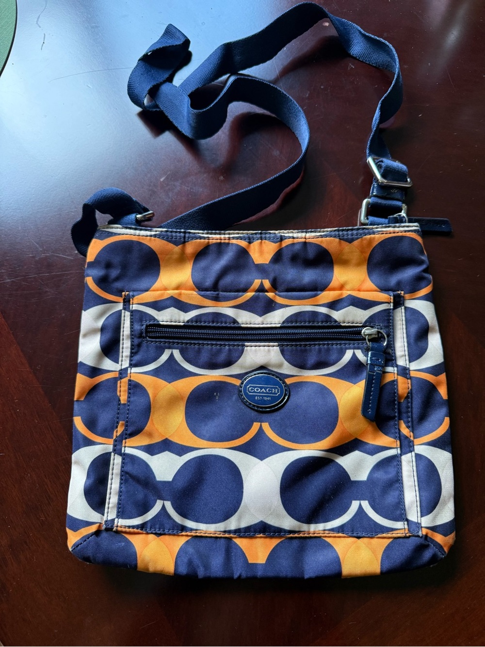 Coach Multicolor monogram Circle Print Crossbody bag in blue orange and cream.